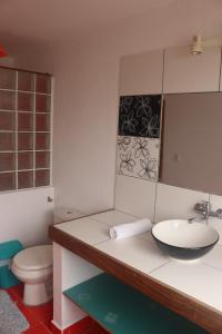 a bathroom with a sink and a toilet and a mirror at La Selenita in Sucre +160 photos