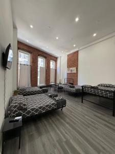 a large room with two beds and a projection screen at 31 Street Broadway Hotel in New York