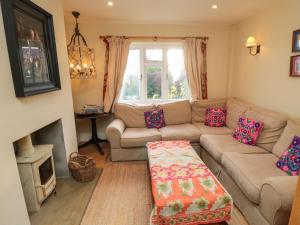 a living room with a couch and a fireplace at St Anthonys in York