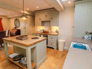 a kitchen with a island in the middle of a room at St Anthonys in York