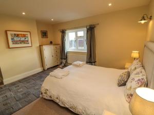 a bedroom with a white bed and a window at St Anthonys in York