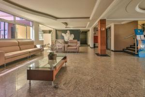 a lobby with couches and a table in a building at Hot Star Thermas Hotel in Caldas Novas