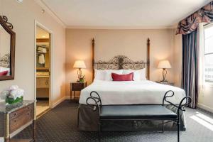 a bedroom with a large white bed and a bench at The Whitehall Hotel - BW Premier Collection in Chicago +31 photos