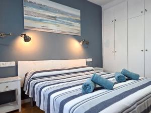 a bedroom with two beds with blue towels on them at Seafront L'Estartit Roof in L'Estartit
