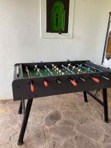 a ping pong table with a board on it at Beau Riad de 3 chambres avec piscine à la rte d'Ourika in El Jemʼa Ghemat