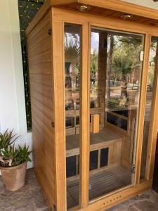 a wooden room with a wooden door with windows at Beau Riad de 3 chambres avec piscine à la rte d'Ourika in El Jemʼa Ghemat