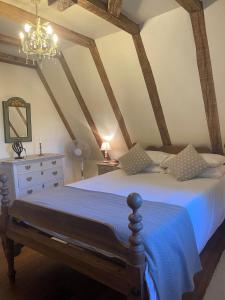 a bedroom with a bed and a chandelier at La Maison du Gardien in La Celle-sous-Gouzon +31 photos