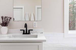 a white bathroom with a sink and a mirror at Valley View in Basye +39 photos