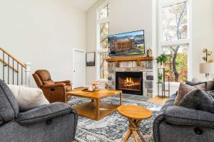 a living room with a fireplace and a tv at Valley View in Basye