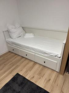 a bed in a room with a white mattress at Modern Compact Studio near Frankfurt in Karben +1 photo