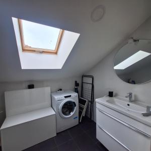 a bathroom with a washing machine and a sink at Ares do mar - Loft and terrace in Matosinhos