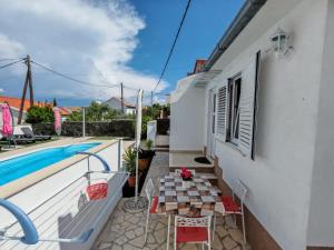 a balcony with a table and a swimming pool at Apartment Mihovilovic in Slatine +47 photos