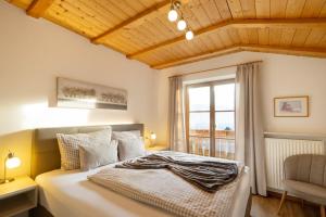 a bedroom with a large bed and a window at Wolkanhof Vineyard Apartments in Appiano sulla Strada del Vino +64 photos