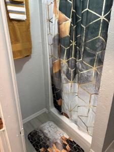 a shower with a shower curtain in a bathroom at Urban Oasis in Jacksonville +54 photos