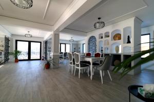 a dining room with a table and chairs at Zodia Craiului in Peştera +43 photos