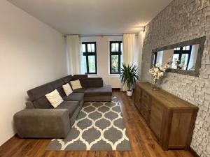 a living room with a couch and a tv at An der Neiße in Görlitz