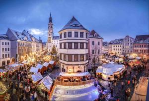 a city with a christmas market in front of a building at An der Neiße in Görlitz