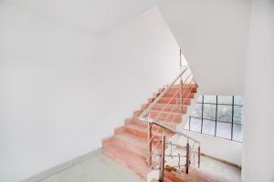 a staircase in a house with a window at Hotel O Ganpati in Bhopal