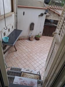 a view of a patio with a table and a bench at B&B I Gigli in Brusciano