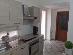 a kitchen with a sink and a counter top at B&B I Gigli in Brusciano +8 photos