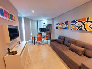 a living room with a couch and a table at Book Santos Mar à Vista no Unique Residence 1810 in Santos