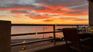 a balcony with a view of the ocean at sunset at Serigor Bahía Ocean View in Puerto de Santiago