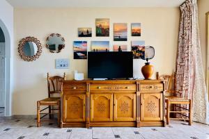 a television on top of a wooden cabinet in a room at Serigor Bahía Ocean View in Puerto de Santiago