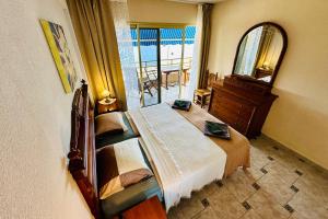 a bedroom with a large bed and a mirror at Serigor Bahía Ocean View in Puerto de Santiago