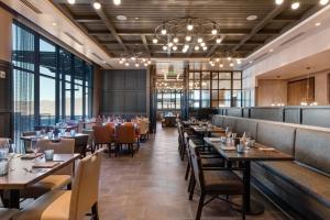 a restaurant with tables and chairs and large windows at Abode at Deer Valley East in Park City