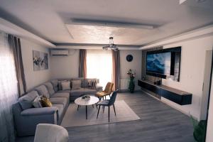 a living room with a couch and a table at Villa Laguna Mostar in Mostar