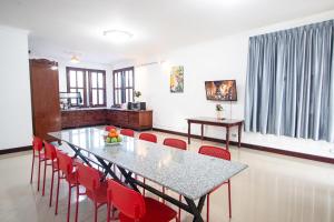 a dining room with a table and red chairs at Private pool Villa3rooms in Siem Reap
