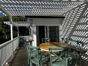 a wooden table and chairs on a deck at Laguna Cove Hotel in Laguna Beach