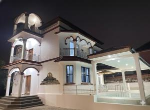 a large white house with a porch at Private pool Villa3rooms in Siem Reap