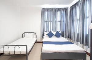a bedroom with two beds and a window at Private pool Villa3rooms in Siem Reap +27 photos