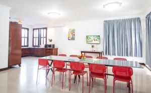 a dining room with a table and red chairs at Private pool Villa3rooms in Siem Reap