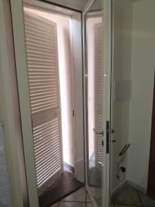 a bathroom with a glass door and a glass shower stall at B&B I Gigli in Brusciano