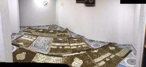a room with four quilts on the floor at Modern Hotel with Free Wi-Fi Parking,210 in Muzaffarabad