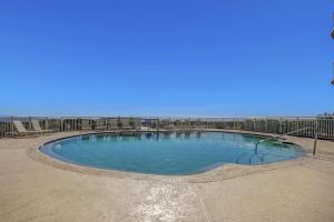 a large swimming pool with blue water at Oceanfront 5th-floor condo with balcony, gorgeous views & pool access in Fernandina Beach