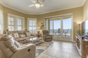 a living room with a couch and chairs and a balcony at Oceanfront 5th-floor condo with balcony, gorgeous views & pool access in Fernandina Beach