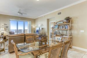 a living room with a glass table and chairs at Oceanfront 5th-floor condo with balcony, gorgeous views & pool access in Fernandina Beach