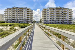 a boardwalk over the beach with two condos at Oceanfront 5th-floor condo with balcony, gorgeous views & pool access in Fernandina Beach