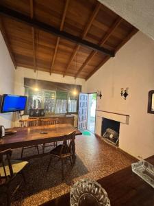 a living room with a wooden table and a fireplace at casa en escobar con cocheras in Belén de Escobar