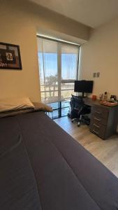 a bedroom with a bed and a desk with a computer at Modern apartment in Angelopolis - 2 bedrooms in Tlazcalancingo +19 photos