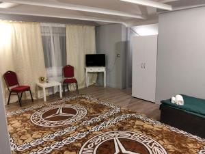 a hotel room with a bed and a living room at Villa Varzob lll in Warsaw