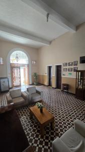 a large living room with couches and a coffee table at Hotel Skal Inn in Barranquilla +12 photos