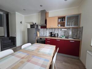 a kitchen with a table and a kitchen with red cabinets at Harznester Schierke in Schierke