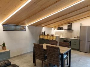 a kitchen with a table and chairs in a room at El Freixe de l'Ylla in Els Hostalets