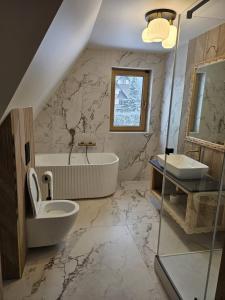 a bathroom with a sink toilet and a tub at WHY NOT Myśliwska Exclusive Residence z basenem in Kościelisko