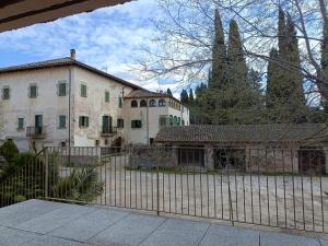 a large house with a fence in front of it at El Freixe de l'Ylla in Els Hostalets