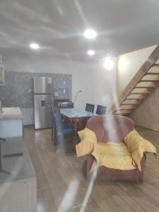 a kitchen and dining room with a couch and a table at Cabañas Drü 3 in Coihaique